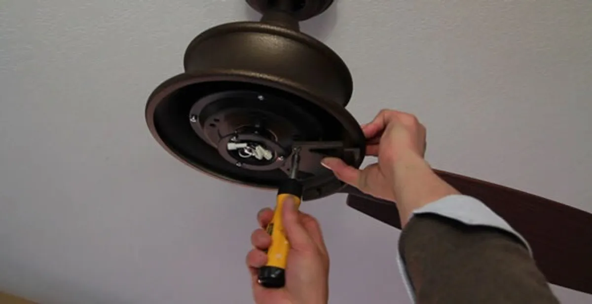 Electrician installing ceiling fan mounting bracket and fixture in Flagstaff, AZ